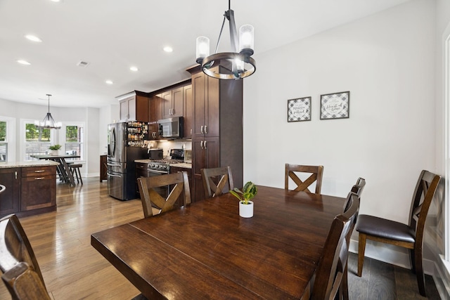 121 Regency Ln, Dickson, TN 37055 - dining area with a chandelier, recessed lighting, wood finished floors, and baseboards