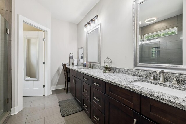 121 Regency Ln, Dickson, TN 37055 - bathroom with double vanity, tiled shower, and baseboards