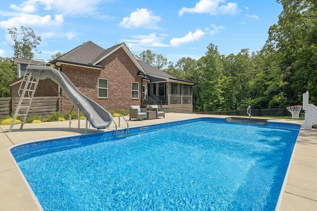121 Regency Ln, Dickson, TN 37055 - view of swimming pool featuring a sunroom, a water slide, a patio, and a fenced backyard