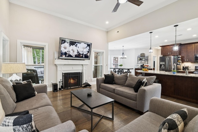 121 Regency Ln, Dickson, TN 37055 - living area featuring recessed lighting, ceiling fan, a warm lit fireplace, dark wood-style floors, and ornamental molding