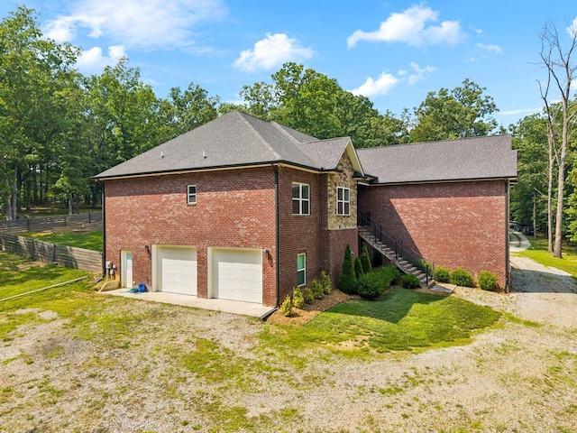 121 Regency Ln, Dickson, TN 37055 - view of side of home featuring brick siding, a garage, stairs, and driveway