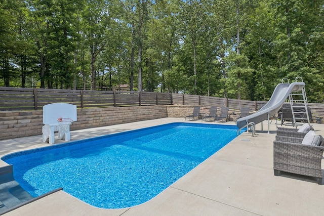 121 Regency Ln, Dickson, TN 37055 - view of pool with a water slide, a patio, a fenced backyard, and view of wooded area