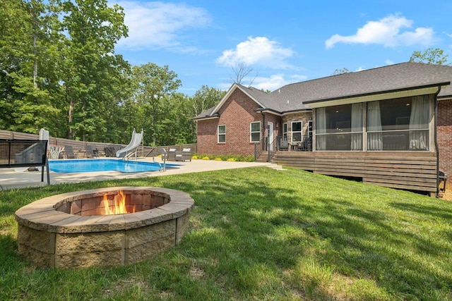 121 Regency Ln, Dickson, TN 37055 - view of pool featuring a water slide, an outdoor fire pit, a patio, a yard, and a sunroom