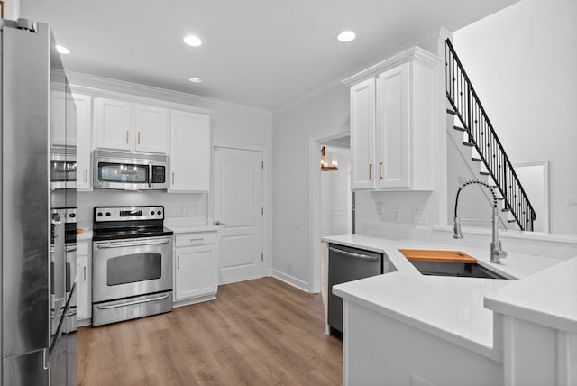 3692 Prestwicke Pl, Adams, TN 37010 - kitchen featuring appliances with stainless steel finishes, white cabinetry, recessed lighting, ornamental molding, and light countertops