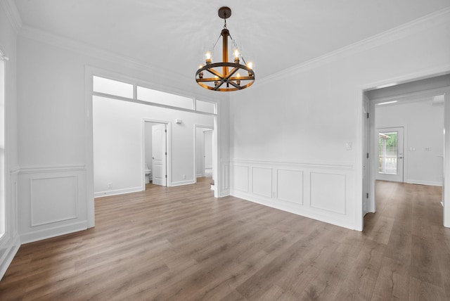 3692 Prestwicke Pl, Adams, TN 37010 - unfurnished dining area with a chandelier, crown molding, light wood-style flooring, a decorative wall, and wainscoting