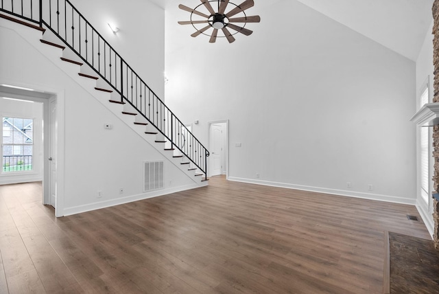 3692 Prestwicke Pl, Adams, TN 37010 - unfurnished living room with high vaulted ceiling, a ceiling fan, stairs, and dark wood-style floors