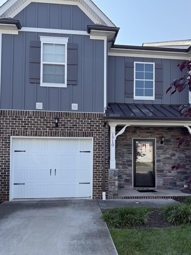 1710 Lone Jack Ln, Murfreesboro, TN 37129 - view of front of property with board and batten siding, brick siding, a garage, concrete driveway, and a standing seam roof