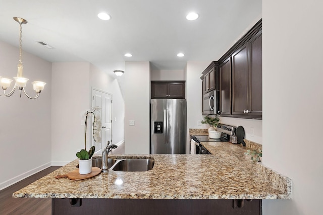 1710 Lone Jack Ln, Murfreesboro, TN 37129 - kitchen with stainless steel appliances, a sink, dark brown cabinetry, dark wood-style floors, and light stone countertops