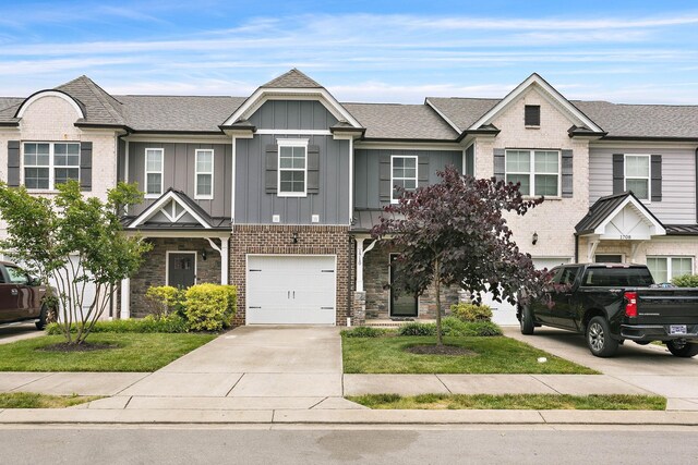 1710 Lone Jack Ln, Murfreesboro, TN 37129 - view of property with driveway, board and batten siding, an attached garage, stone siding, and brick siding