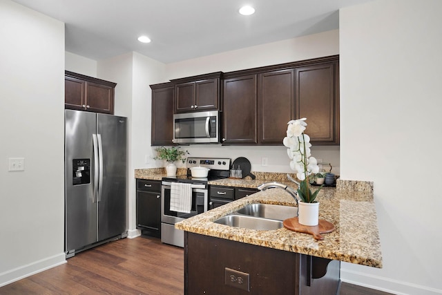 1710 Lone Jack Ln, Murfreesboro, TN 37129 - kitchen featuring appliances with stainless steel finishes, a sink, a peninsula, dark brown cabinetry, and baseboards