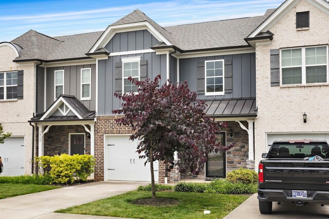1710 Lone Jack Ln, Murfreesboro, TN 37129 - view of front of house with a garage, board and batten siding, driveway, a standing seam roof, and brick siding