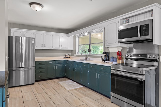 51 N Case Ave, Trenton, GA 30752 - kitchen featuring appliances with stainless steel finishes, a sink, white cabinets, and blue cabinets