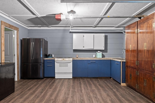 51 N Case Ave, Trenton, GA 30752 - kitchen with white range with electric stovetop, freestanding refrigerator, light countertops, and blue cabinets