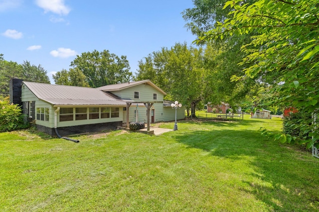 51 N Case Ave, Trenton, GA 30752 - back of property with a patio area, a lawn, metal roof, and a pergola