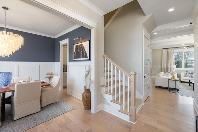 140 Barlow Dr, Franklin, TN 37064 - dining space with a chandelier, stairs, crown molding, a decorative wall, and wood finished floors