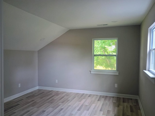 657 Chaffin Rd, Lafayette, TN 37083 - bonus room with light wood finished floors, plenty of natural light, vaulted ceiling, and baseboards