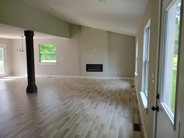 657 Chaffin Rd, Lafayette, TN 37083 - unfurnished living room featuring lofted ceiling, light wood-style floors, plenty of natural light, a fireplace, and baseboards
