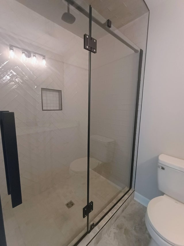 657 Chaffin Rd, Lafayette, TN 37083 - bathroom with toilet, a stall shower, and baseboards