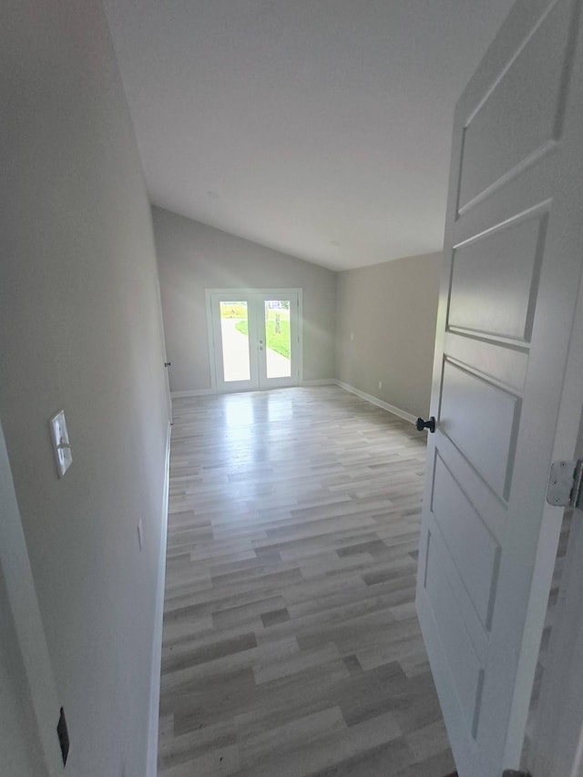 657 Chaffin Rd, Lafayette, TN 37083 - empty room with vaulted ceiling, wood finished floors, baseboards, and french doors