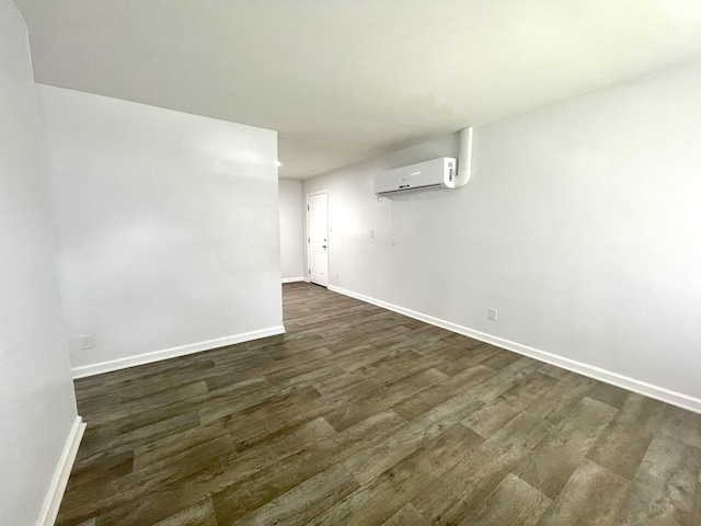 1804 Mchenry Dr, Hopkinsville, KY 42240 - spare room featuring an AC wall unit, baseboards, and dark wood finished floors