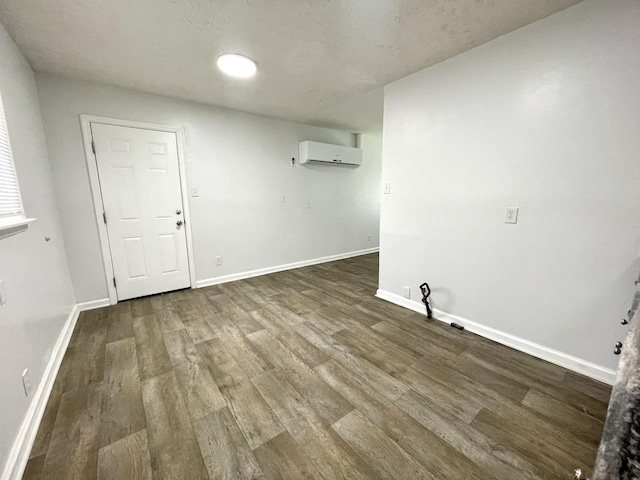 1804 Mchenry Dr, Hopkinsville, KY 42240 - unfurnished room featuring an AC wall unit, dark wood-style floors, and baseboards