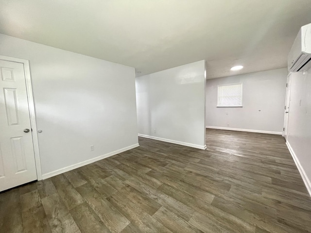 1804 Mchenry Dr, Hopkinsville, KY 42240 - empty room featuring an AC wall unit, baseboards, dark wood-style flooring, and recessed lighting