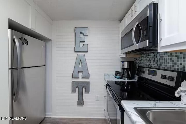 413 Baskins Creek Rd Apt 605, Gatlinburg, TN 37738 - kitchen with appliances with stainless steel finishes, white cabinets, tasteful backsplash, and light stone countertops