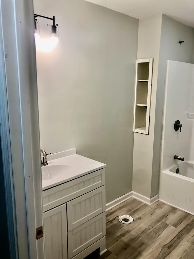 711 Gwen St, Paris, TN 38242 - full bathroom featuring wood finished floors, vanity,  shower combination, and baseboards