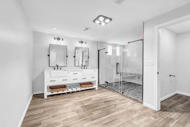 4510 Akin Rd, Cunningham, TN 37052 - bathroom featuring double vanity, a marble finish shower, wood finished floors, and recessed lighting