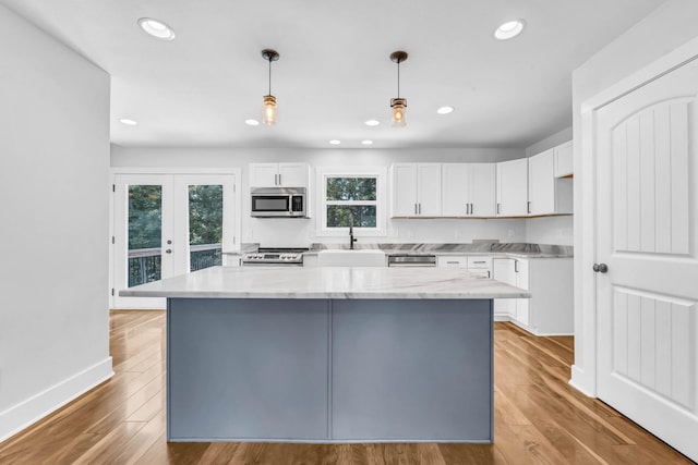 4510 Akin Rd, Cunningham, TN 37052 - kitchen featuring stainless steel appliances, white cabinets, a center island, recessed lighting, and light wood-style flooring
