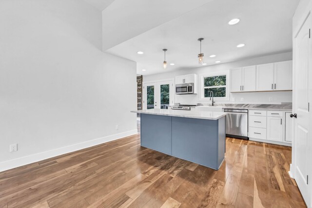 4510 Akin Rd, Cunningham, TN 37052 - kitchen with appliances with stainless steel finishes, white cabinets, a center island, recessed lighting, and light countertops