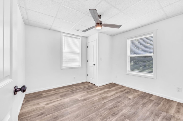 4510 Akin Rd, Cunningham, TN 37052 - unfurnished room with wood finished floors, a drop ceiling, and a ceiling fan