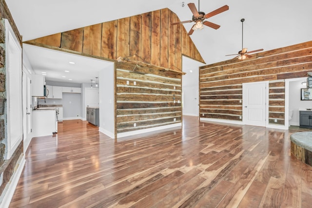 4510 Akin Rd, Cunningham, TN 37052 - unfurnished living room featuring high vaulted ceiling, a ceiling fan, wooden walls, and wood finished floors