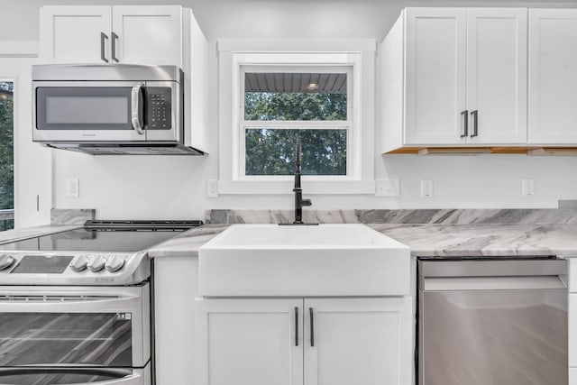 4510 Akin Rd, Cunningham, TN 37052 - kitchen with appliances with stainless steel finishes, white cabinetry, and light stone counters