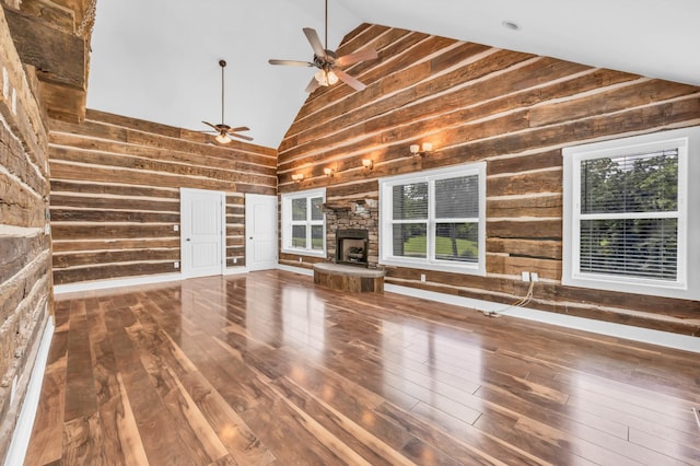 4510 Akin Rd, Cunningham, TN 37052 - unfurnished living room featuring high vaulted ceiling, wood walls, a ceiling fan, hardwood / wood-style floors, and a fireplace