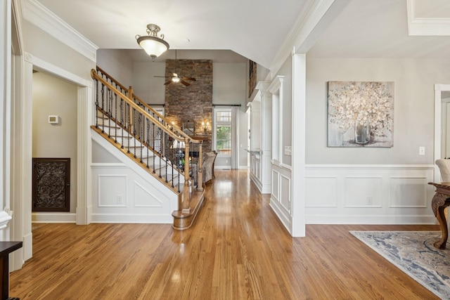 2064 Catalina Way, Nolensville, TN 37135 - entrance foyer featuring stairway, wood finished floors, a decorative wall, a ceiling fan, and crown molding