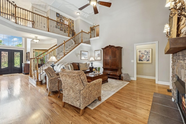 2064 Catalina Way, Nolensville, TN 37135 - living area featuring a towering ceiling, stairs, a fireplace, ceiling fan, and light wood finished floors