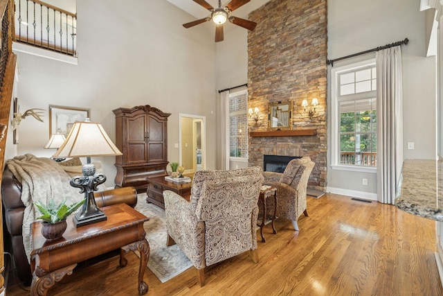 2064 Catalina Way, Nolensville, TN 37135 - living area featuring a high ceiling, a fireplace, a ceiling fan, light wood finished floors, and baseboards
