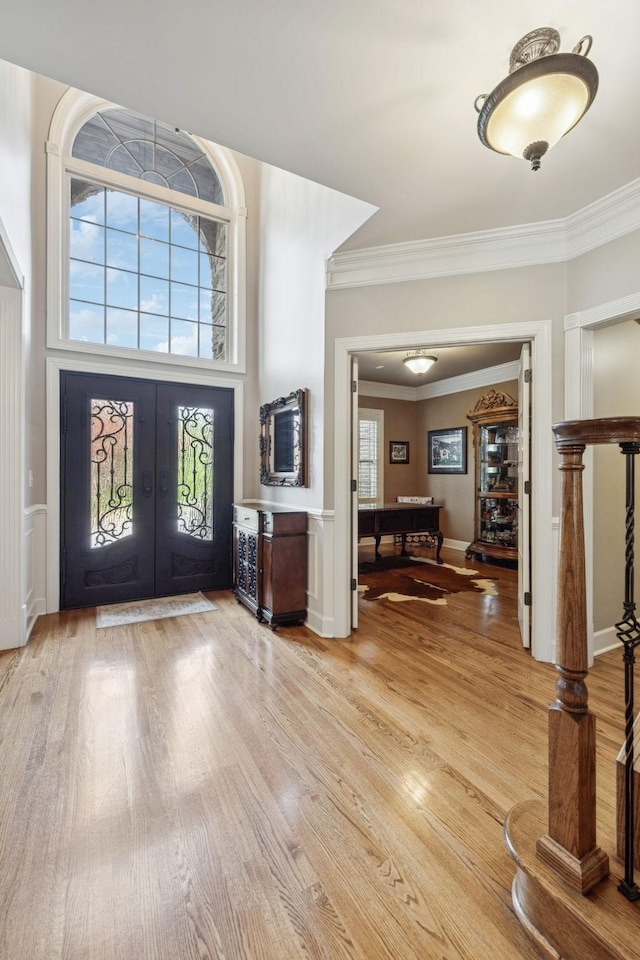 2064 Catalina Way, Nolensville, TN 37135 - foyer entrance with french doors, light wood-type flooring, crown molding, and a wainscoted wall