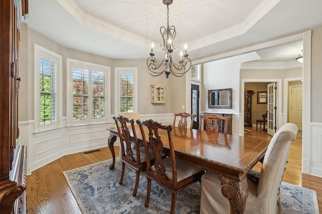 2064 Catalina Way, Nolensville, TN 37135 - dining room featuring a chandelier, a raised ceiling, wood finished floors, crown molding, and a wainscoted wall