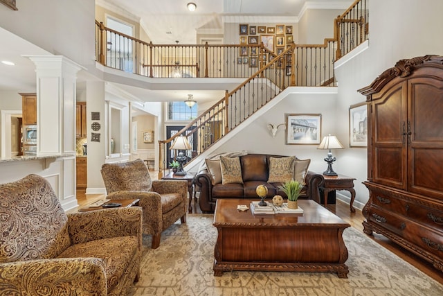 2064 Catalina Way, Nolensville, TN 37135 - living room featuring stairs, a high ceiling, ornamental molding, light wood-type flooring, and baseboards