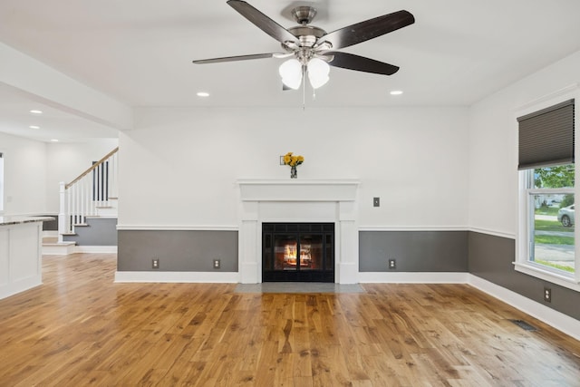 7935 Franklin Rd, Murfreesboro, TN 37128 - unfurnished living room with light wood finished floors, a ceiling fan, recessed lighting, stairs, and a fireplace with flush hearth