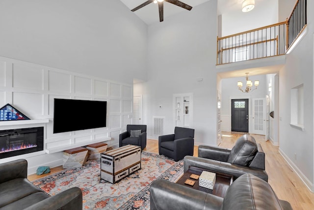 175 Dobson Knob Trl, Nolensville, TN 37135 - living room featuring a high ceiling, a chandelier, light wood-type flooring, ceiling fan, and baseboards