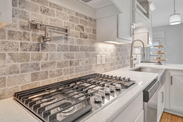175 Dobson Knob Trl, Nolensville, TN 37135 - kitchen with appliances with stainless steel finishes, tasteful backsplash, white cabinets, hanging light fixtures, and a sink