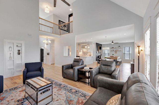 175 Dobson Knob Trl, Nolensville, TN 37135 - living room featuring ceiling fan, a towering ceiling, light wood-type flooring, a chandelier, and baseboards