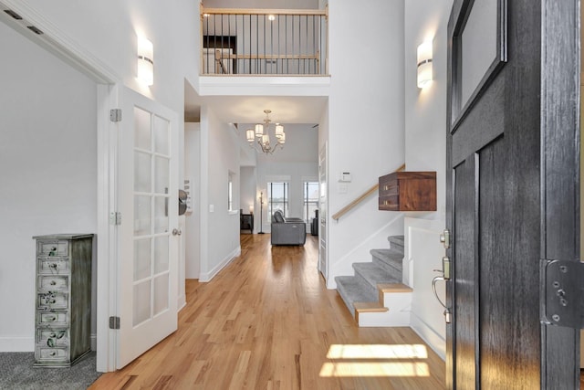 175 Dobson Knob Trl, Nolensville, TN 37135 - entrance foyer with light wood finished floors, a high ceiling, a chandelier, stairway, and baseboards