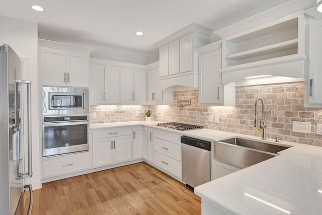 175 Dobson Knob Trl, Nolensville, TN 37135 - kitchen featuring appliances with stainless steel finishes, a sink, white cabinets, decorative backsplash, and light stone countertops