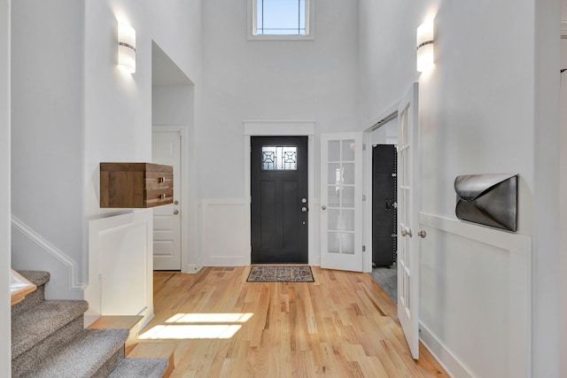 175 Dobson Knob Trl, Nolensville, TN 37135 - entrance foyer featuring a high ceiling, light wood-style floors, stairway, and wainscoting