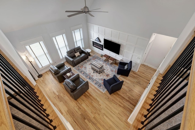175 Dobson Knob Trl, Nolensville, TN 37135 - living area with wood finished floors, a fireplace, a ceiling fan, high vaulted ceiling, and baseboards