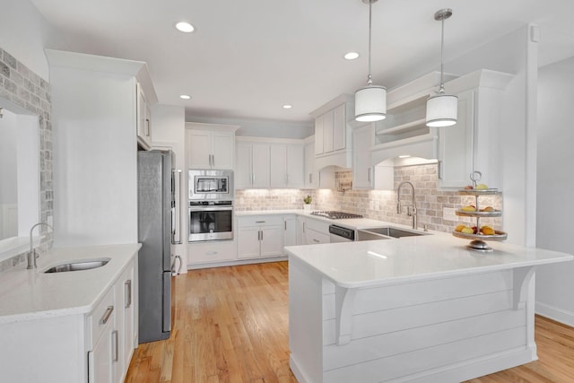175 Dobson Knob Trl, Nolensville, TN 37135 - kitchen featuring stainless steel appliances, a sink, a peninsula, white cabinetry, and recessed lighting